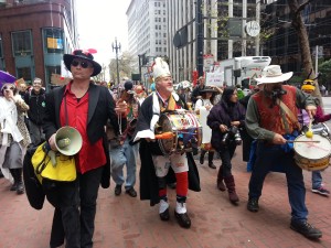 St. Stupid’s Day parade founder Ed Holmes, center, marches with revelers for the annual procession. Photo: Zack Farmer