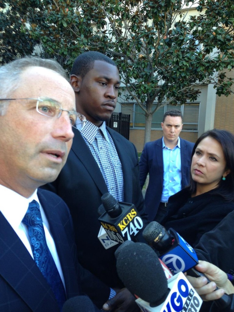 San Francisco 49ers linebacker Aldon Smith stands next to  his attorney, Josh Bentley, after his court appearance in San Jose On November 12, 2013.